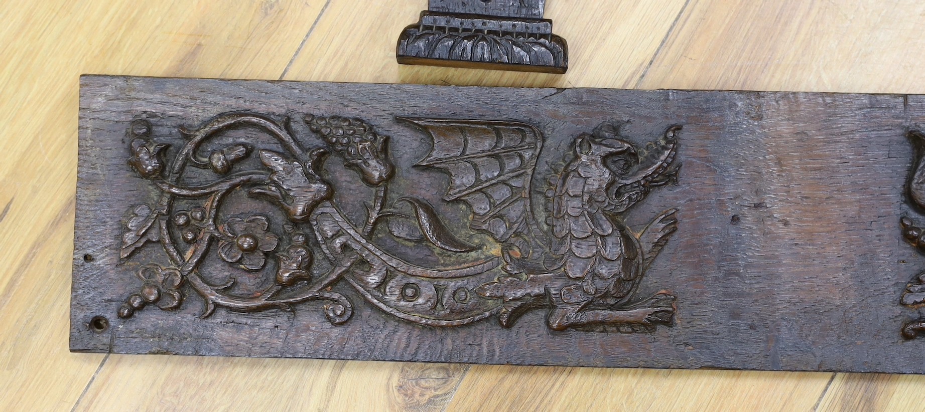A 17th carved oak figural corbel, a pair of carved oak corbels and a carved oak frieze 14x19cm